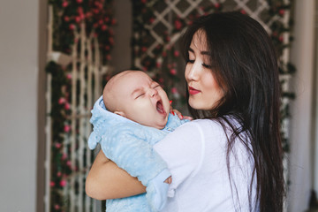 Portrait of a cute asian baby boy yawning