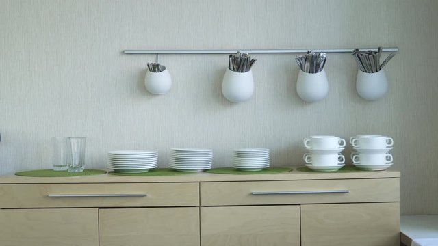 kitchen with table and cutlery on the wall