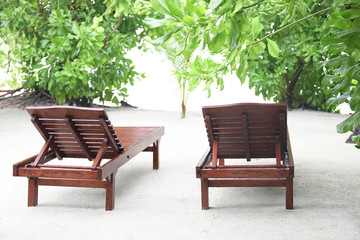 Sun loungers on beach at sea resort