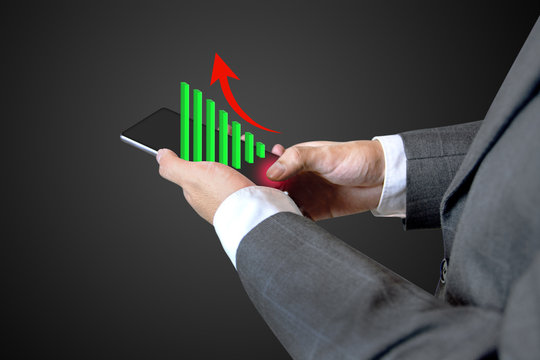 Closeup of Business man touch social network structure of Digital composite with graph business diagram on smartphone background.