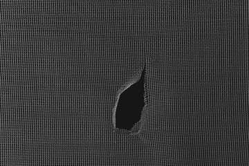 Torn window screen, closeup
