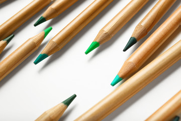 Obraz premium Pencils of green shades on white background
