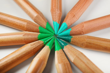Pencils of green shades on white background