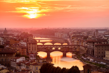 Fototapeta na wymiar Beautiful sunset at the medieval city of Florence with a view of the Ponte Vecchio and the river Arno
