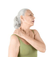 Elderly woman suffering from pain in shoulder on white background