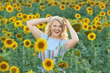 Blonde woman in sunflower field