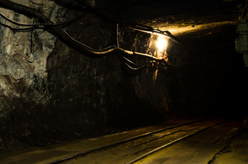 Naklejka premium Underground mining tunnel with rails