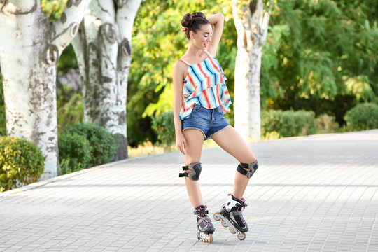 Young woman rollerskating in park
