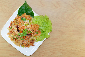 spicy minced pork salad, minced pork mash with spicy, Thai food on the wood background.
