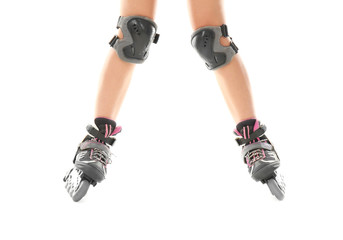 Legs of woman on roller skates against white background © Africa Studio