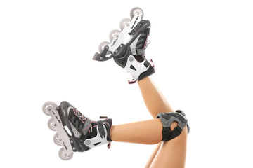 Legs of woman on roller skates against white background