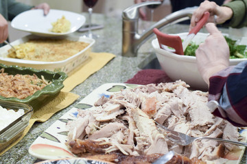 People serving themselves Thanksgiving dinner