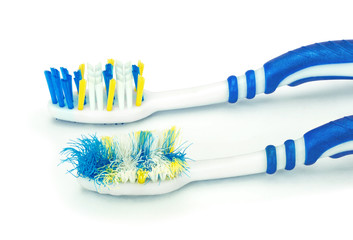 Изношенная и новая зубные щетки на изолированном белом фоне