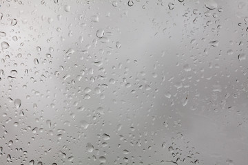 weather, background, uniqueness concept. close up of the window, there are lots of rain drops on it, they are like snowflakes very special, each has its own size and form