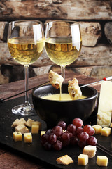 Gourmet Swiss fondue dinner on a winter evening with assorted ch