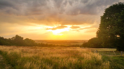 Sunset on the beautiful meadow of the French countryside.