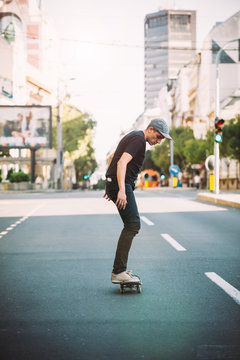 Professional skater riding skate on streets through cars and traffic