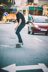 Professional skater riding skate on streets through cars and traffic