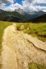 Way in Dolomites with Marmolada peak on the background, Italy