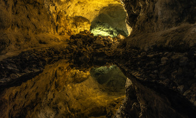 Fototapeta na wymiar Underground lake inside volcanic cave - 