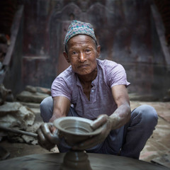 Old potter man working in his pottery,Bhaktapur, Nepal - obrazy, fototapety, plakaty
