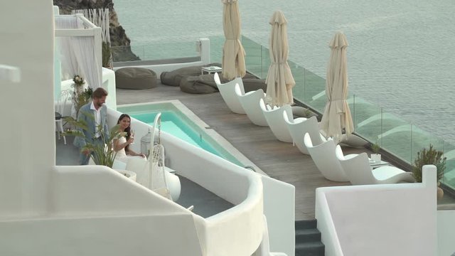 4k travel video honeymoon couple in evening clothes on luxury hotel terrace overlooking the sea