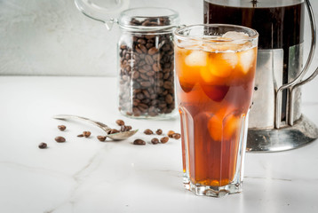 Trendy drinks. Cold brew iced coffee on white marble table. copy space