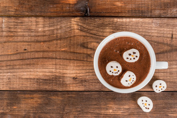 Traditional Christmas drink idea. Hot chocolate mug with marshmallow, decorated in the form of...