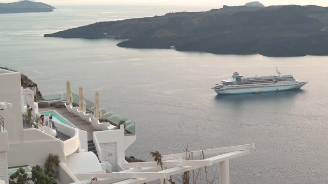 4k travel video amazing view from luxury hotel on santorini island with caldera and cruise ship late afternoon
