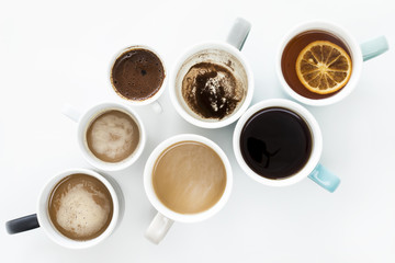 Different cups of coffee on white background