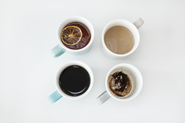 Different cups of coffee on white background