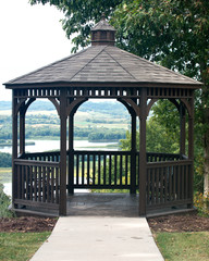 Wooden gazebo in park surrounded by trees