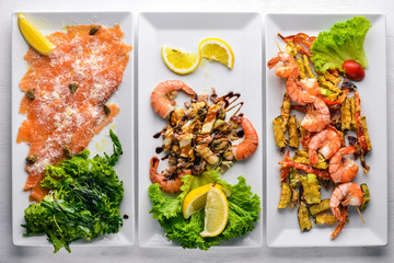 Assorted seafood, salmon, octopus, squid, mussels, shrimp. On a wooden background. Top view. Free space.