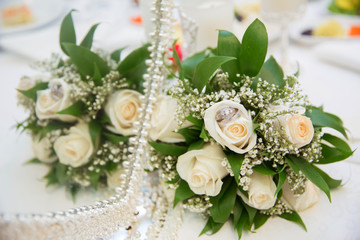 Beautiful white wedding bouquets in basket backgraound bouquet flowers rose / wedding rings