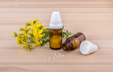 Obraz na płótnie Canvas Homeopathic remedy / Homeopathic remedy with flowering St. John