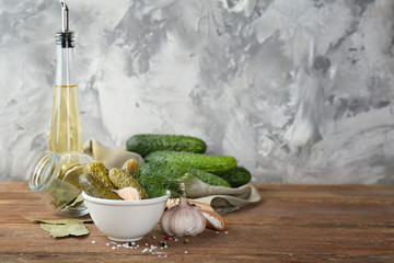 Composition with pickled cucumbers on wooden table