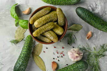 Composition with pickled and fresh cucumbers on gray textured background