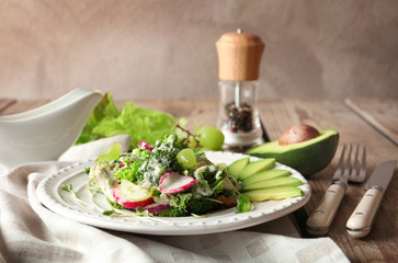 Plate with broccoli salad on table