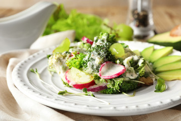 Plate with broccoli salad on table