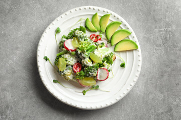 Plate with broccoli salad on table