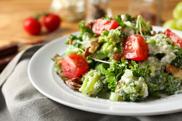 Plate with broccoli salad on table