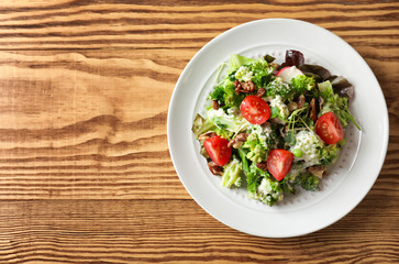 Plate with broccoli salad on table