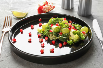 Plate with broccoli salad on table