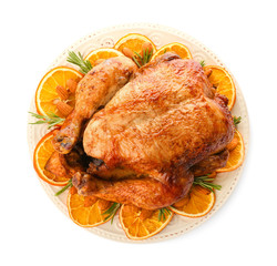 Plate with roasted turkey on white background
