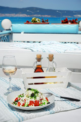 Plate with exotic salad on served table in open air restaurant