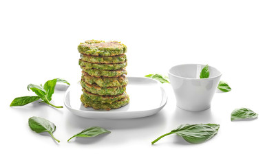 Plate with delicious broccoli pancakes on white background