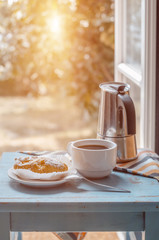 Breakfast on table against opened window