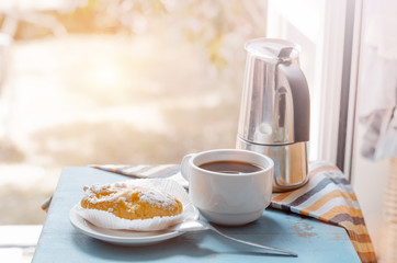 Breakfast on table against opened window
