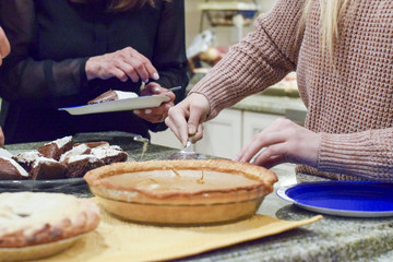 Obraz na płótnie Canvas Hand cutting warm pumpkin pie