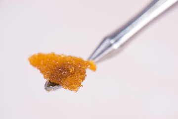 Fototapeta na wymiar Dannabis concentrate live resin (extracted from medical marijuana) isolated over white